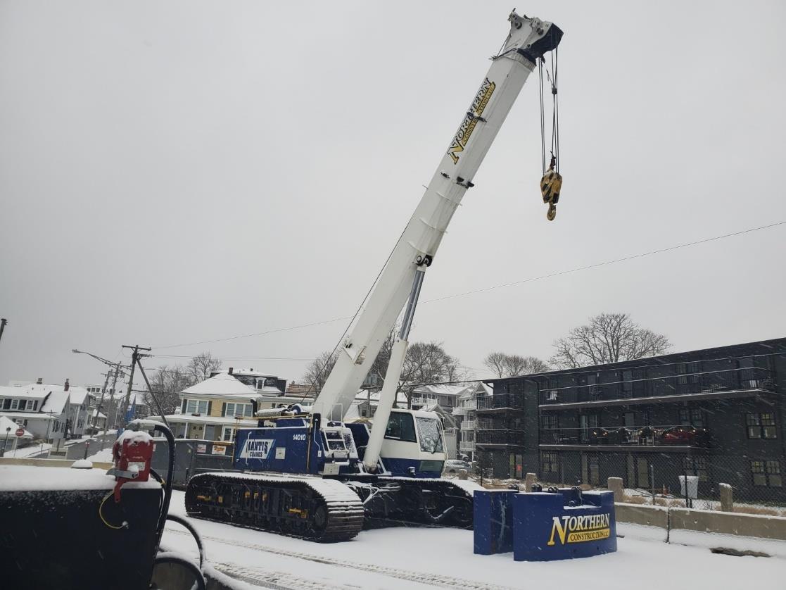 crane for steel sheeting installation on construction site