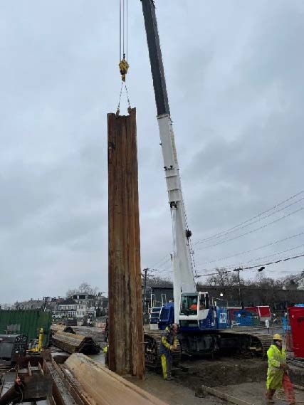 crew driving steel sheeting along Water Street