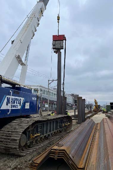 crew driving steel sheeting along Water Street
